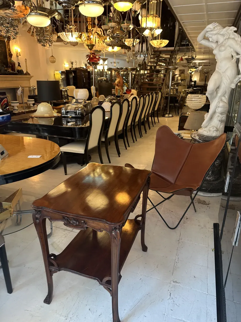 antique small table with a lower shelf in a decorative setting