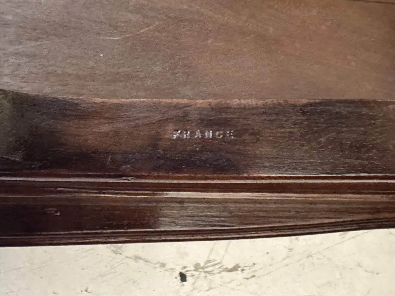 Antique small table with a signature from France in a classic setting.