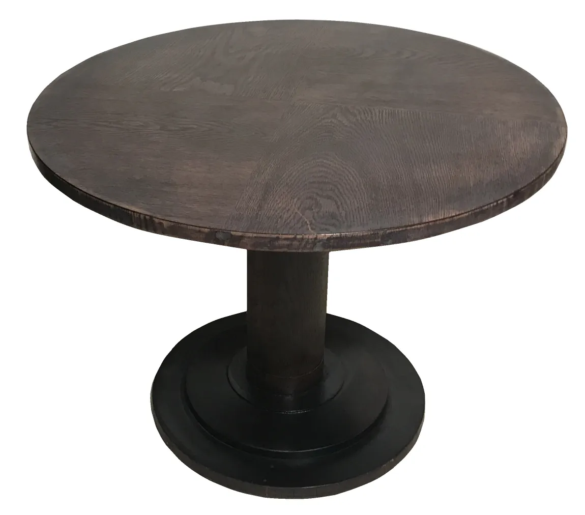 Antique round small table with a cylindrical base and dark color.