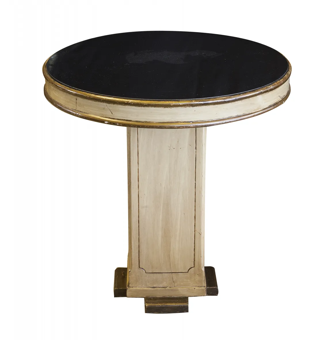 ancienne petite table ronde avec plateau noir et base claire dans une ambiance chaleureuse