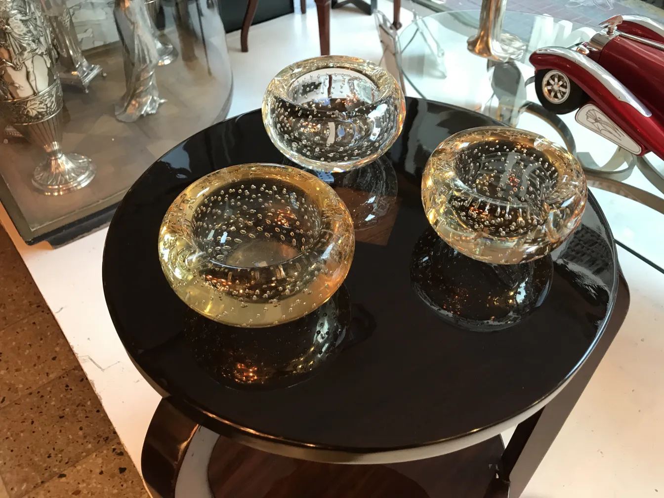 Antique round small table with three decorative bowls on top