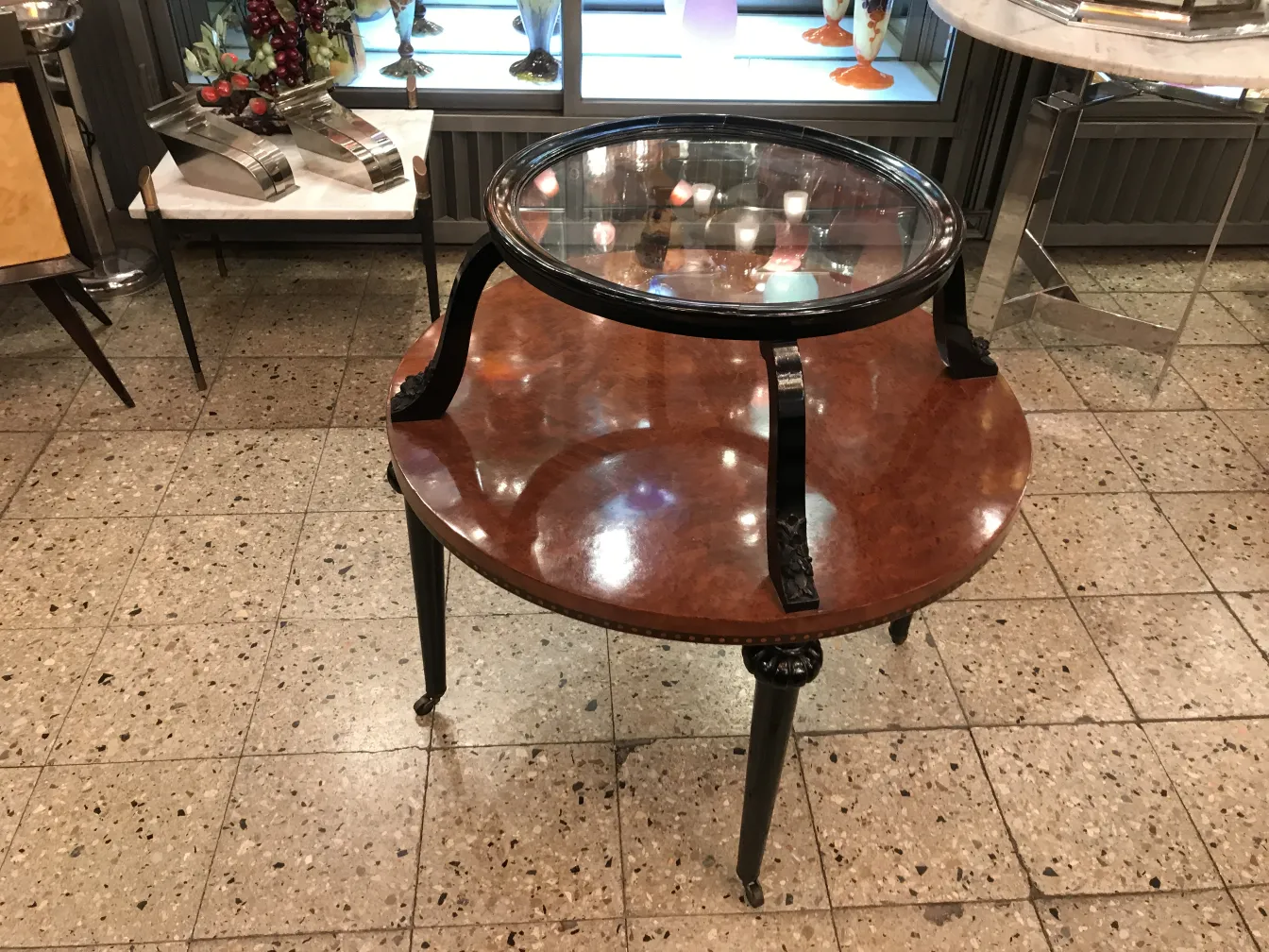 Antique small table with round design and elegant legs in a classic setting.