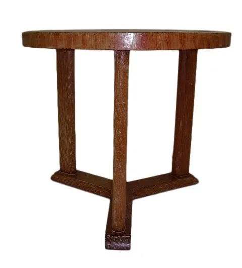 Antique round table with sturdy legs in a neutral setting.