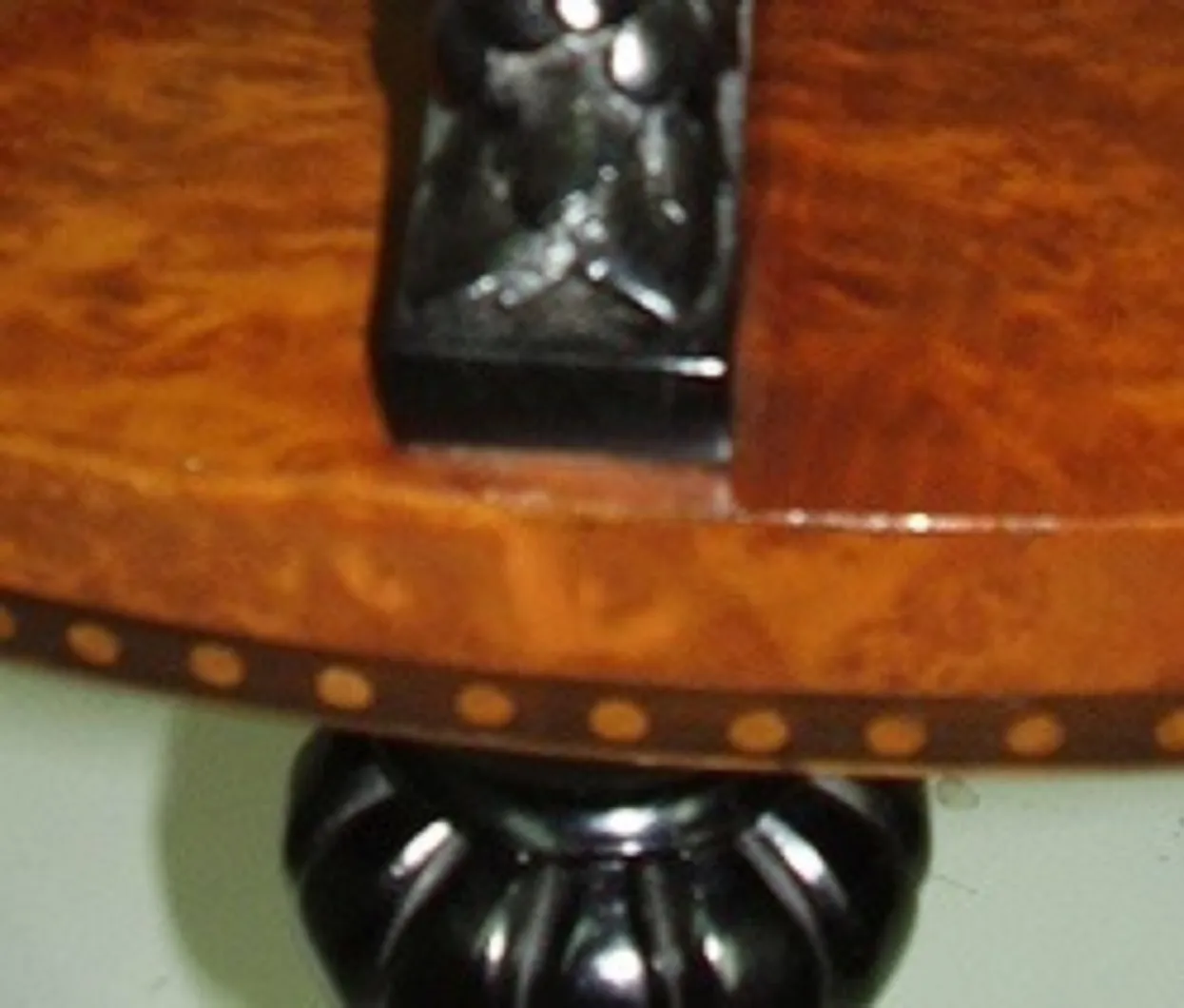 Antique small table with detailed design, neutral background.