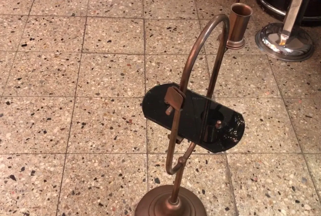 ユニークな曲がったスタンドを持つ古い小さなテーブル、クラシックな設定で。