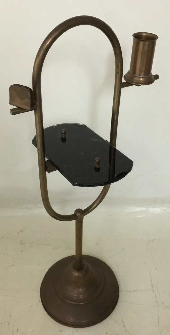 Antique small table design with a candle holder, bronze color.