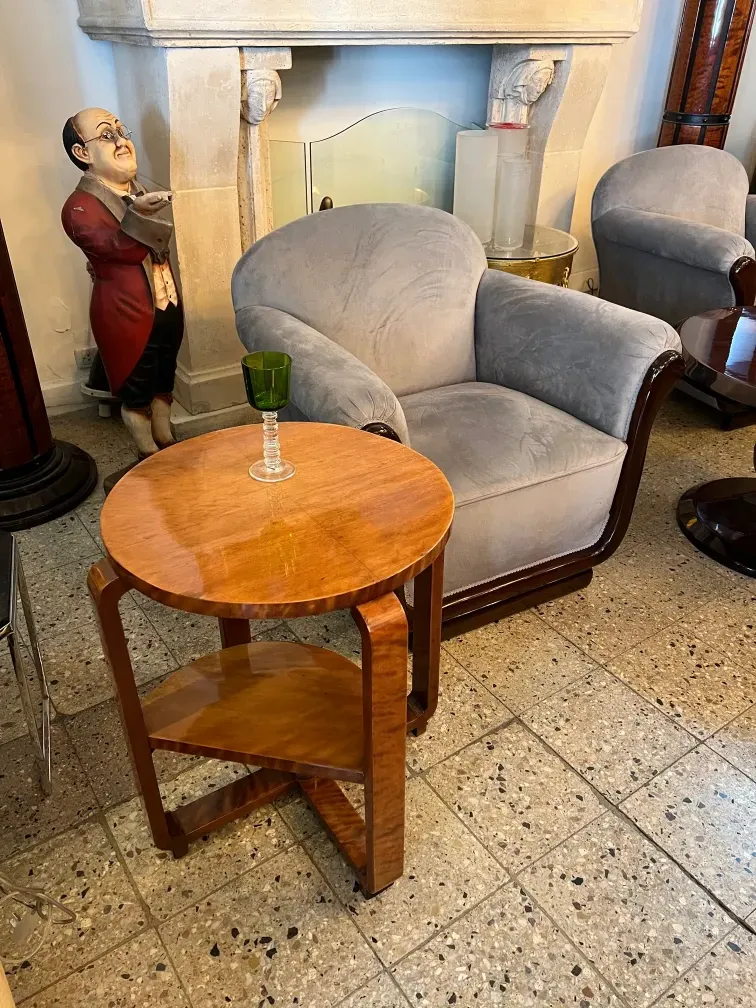 Small antique table with a green vase and chairs