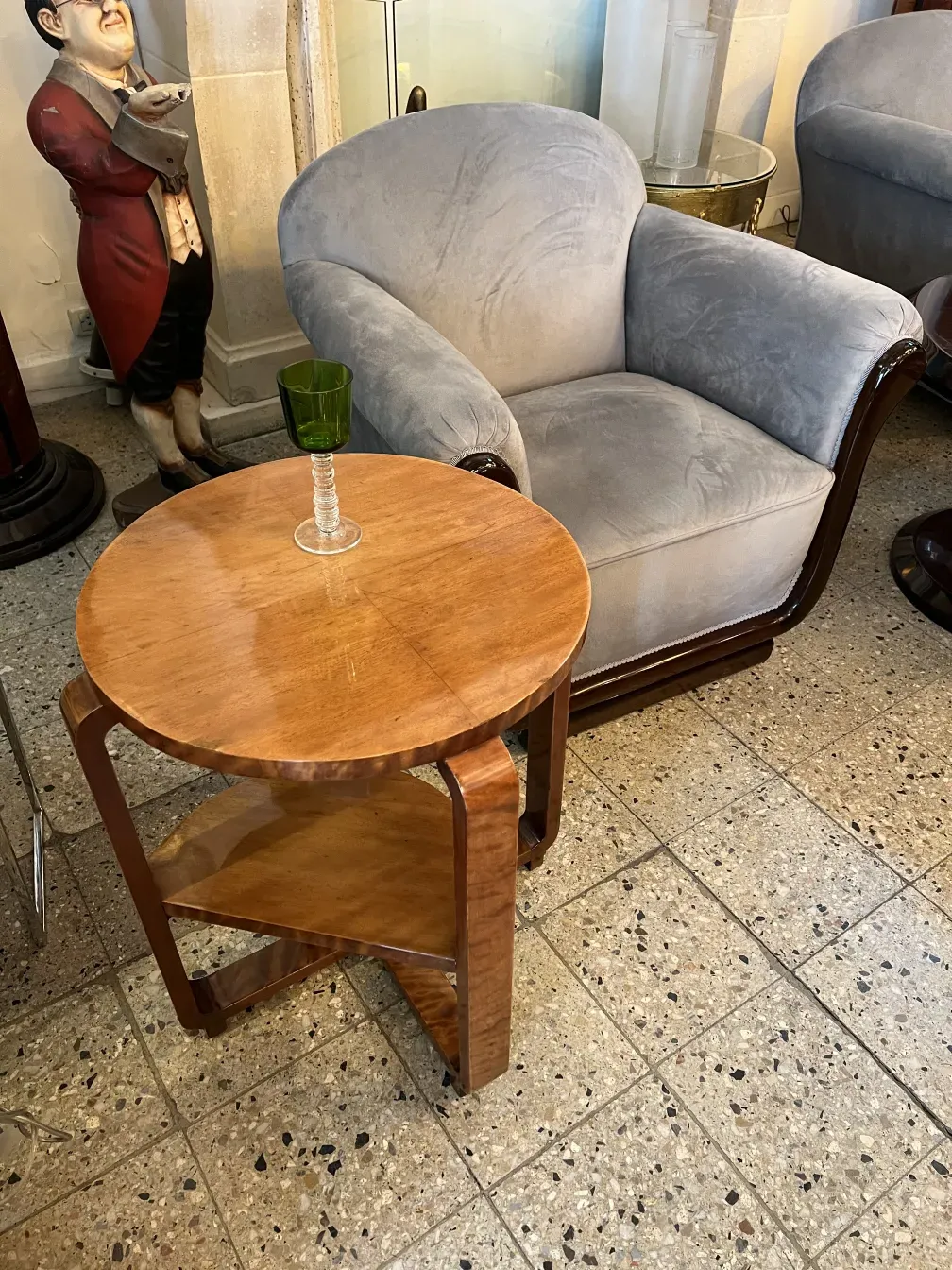 Petite table de soutien ancienne avec une finition lisse et brillante, entourée d'un environnement confortable.