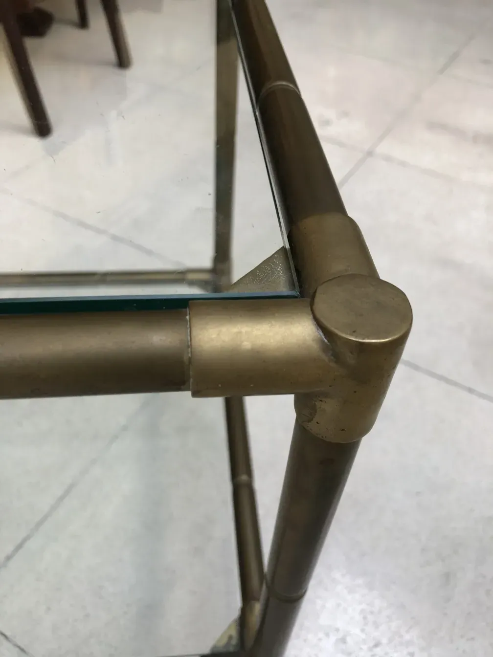 Tavolino antico con gambe in metallo e design semplice.