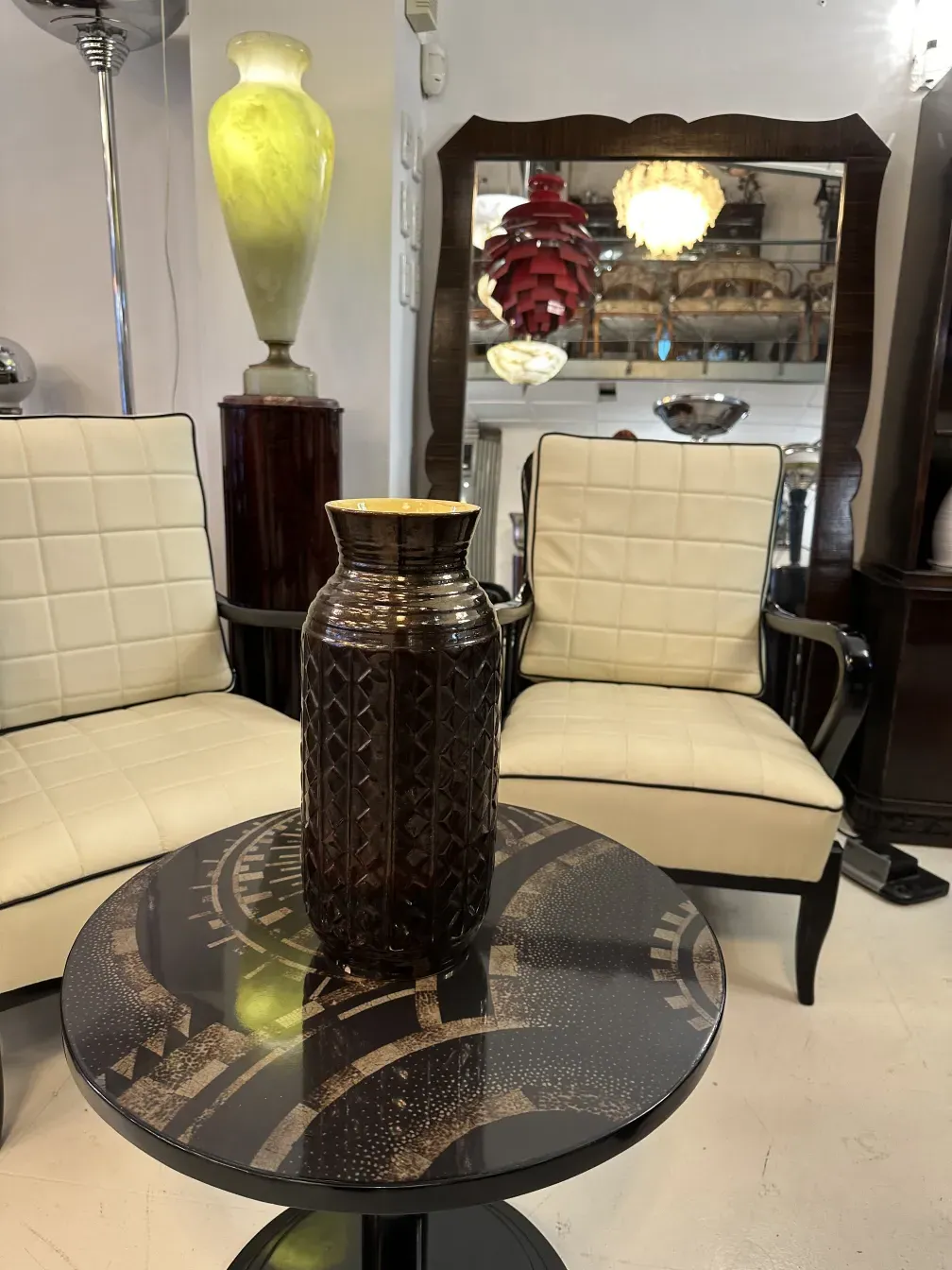 antique small table with a decorative vase on top