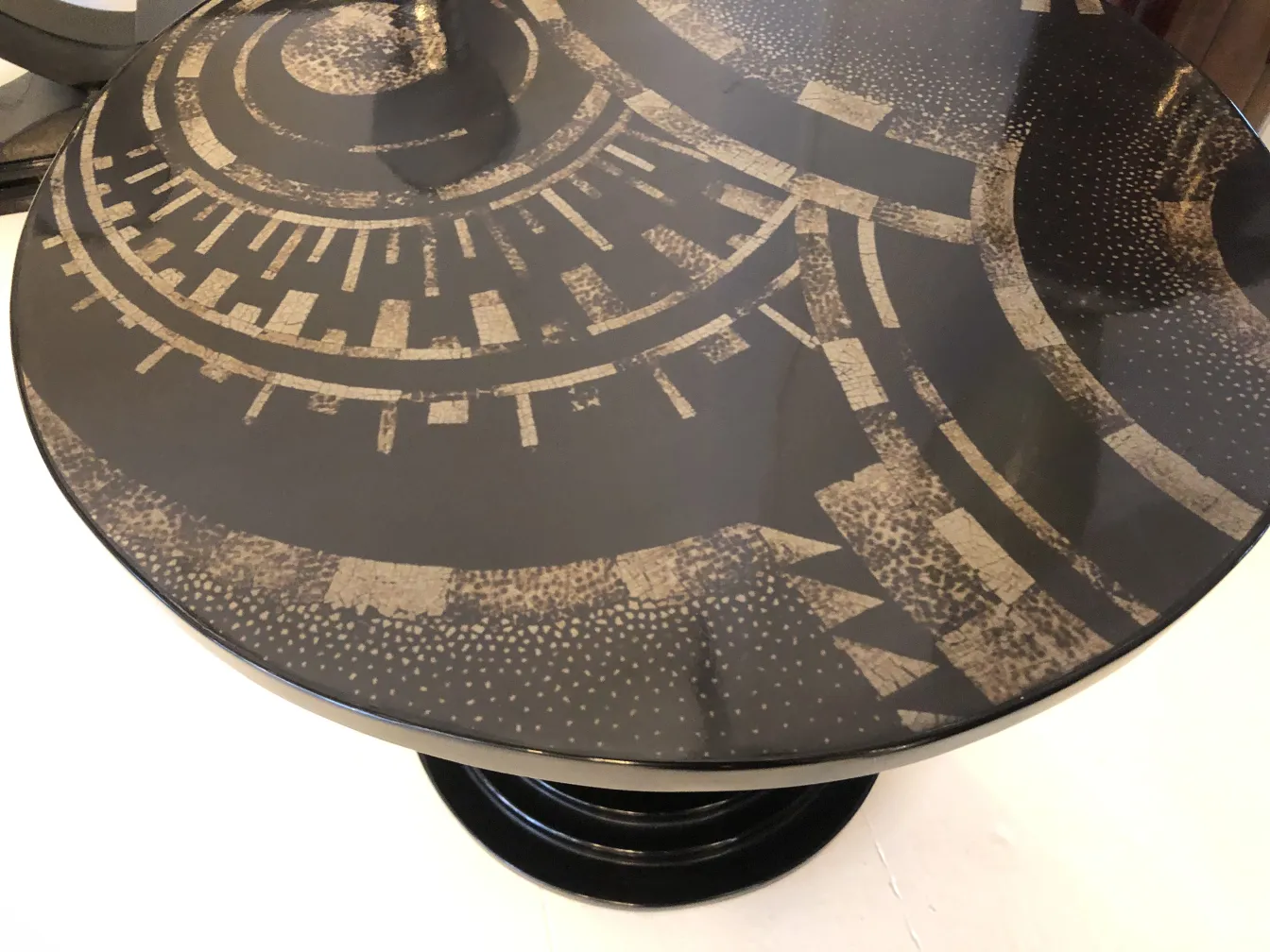 antique small table featuring a modern geometric design and dark colors