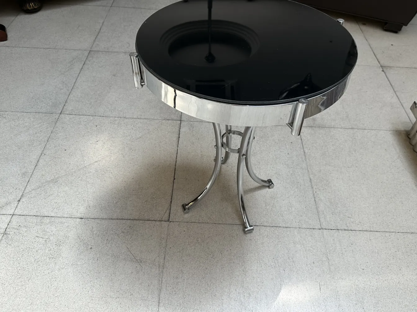 small antique round table with decorative base in a classic setting