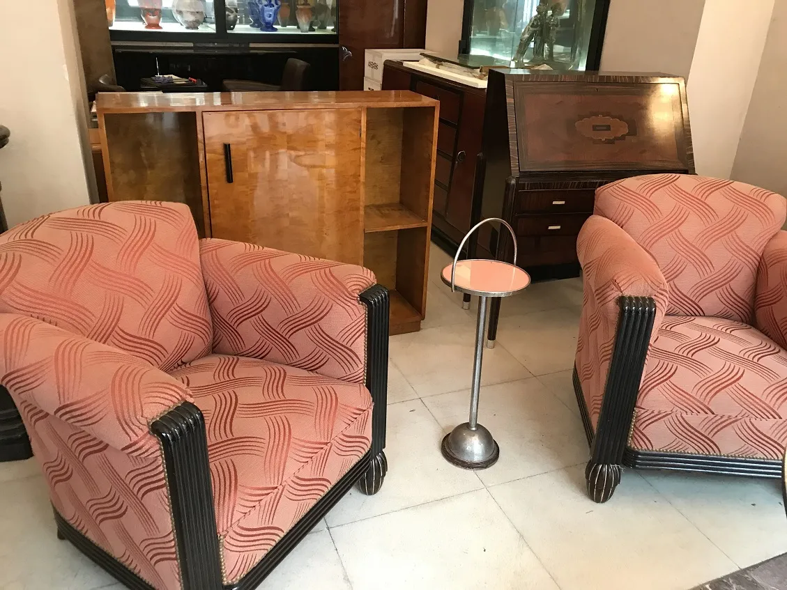 Antique small table near armchairs in classic setting