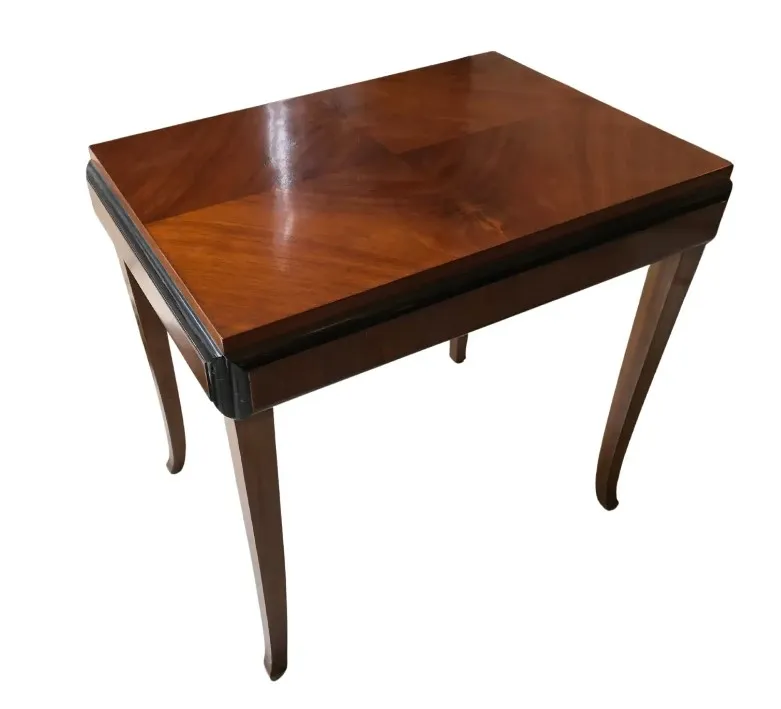 Antique small table with slender legs and a shiny surface.