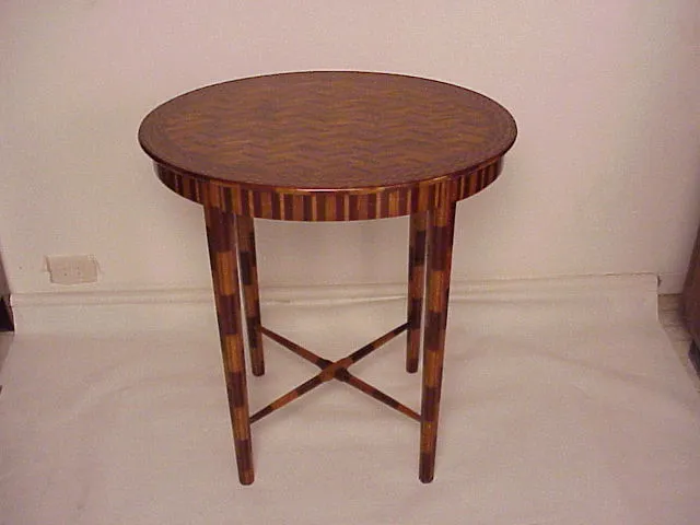antique round small table with elaborate decoration and legs