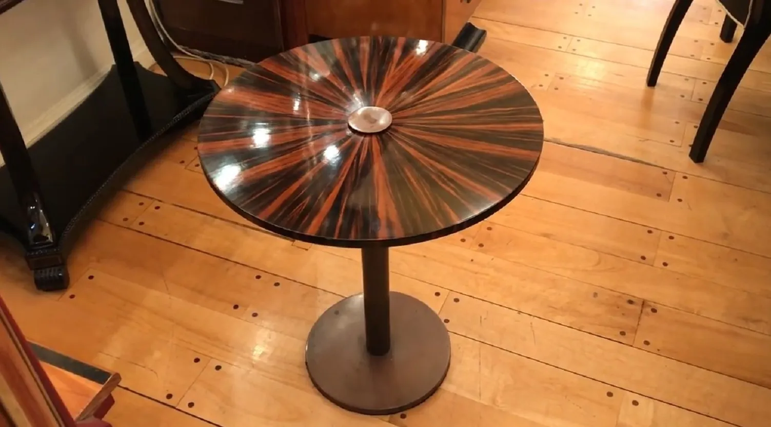 Antique decorative small table with a radial design on the top.