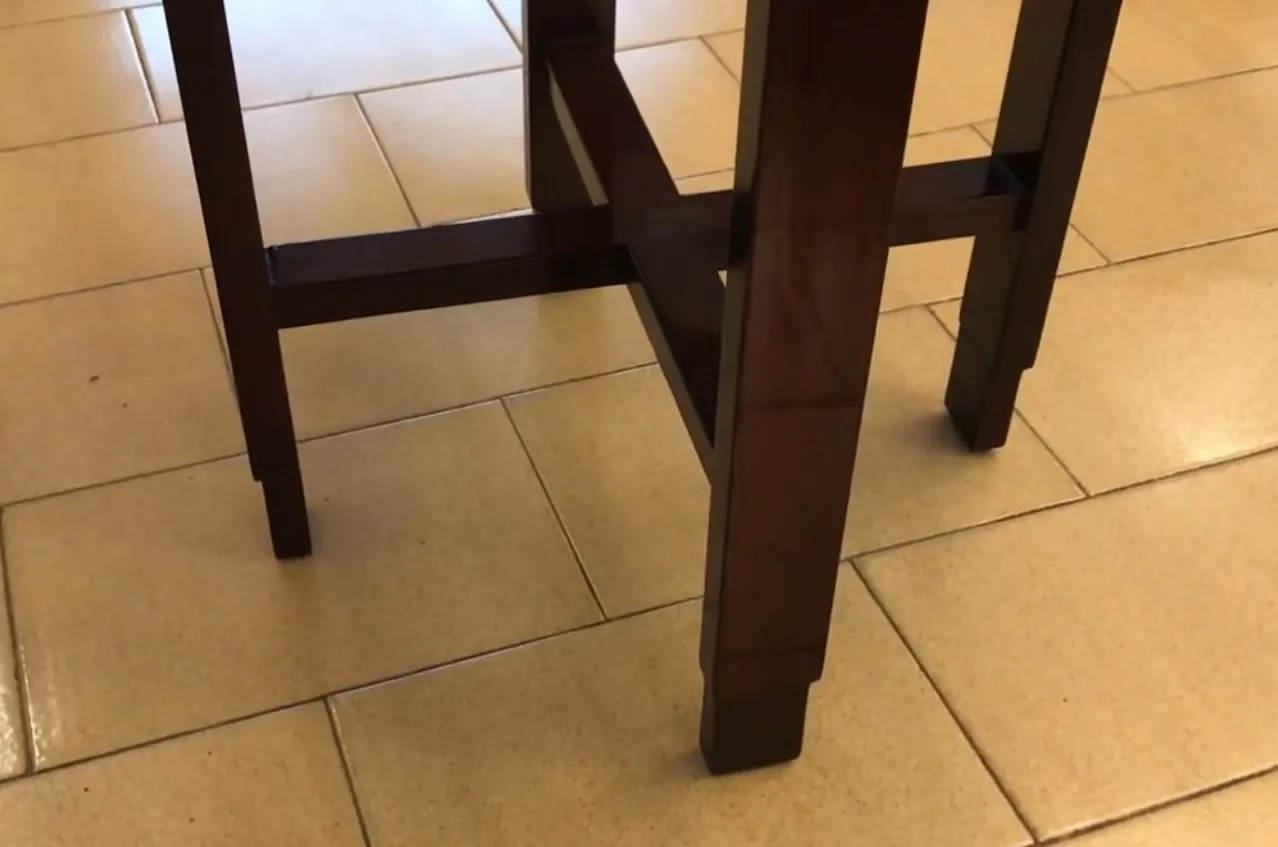 Small antique table with elegant legs in a cozy setting