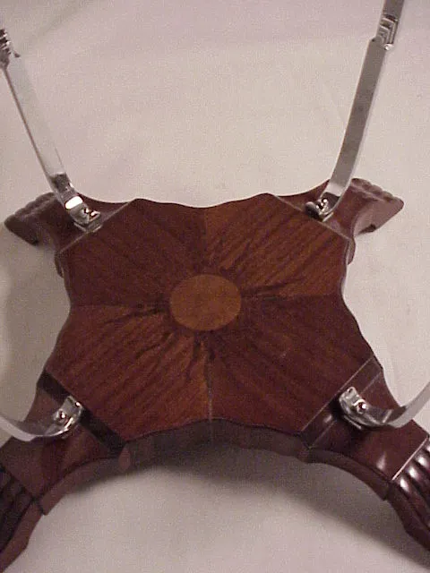 Antique small table showcasing a beautiful floral design on top, part of an elegant setting