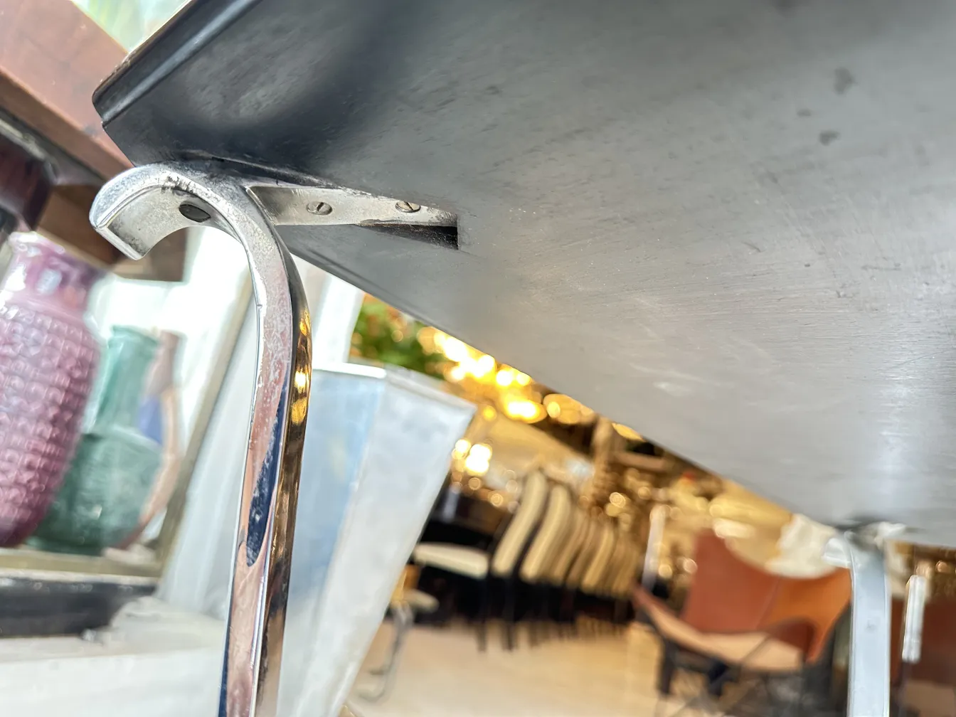 small antique table with curved support in a cozy setting