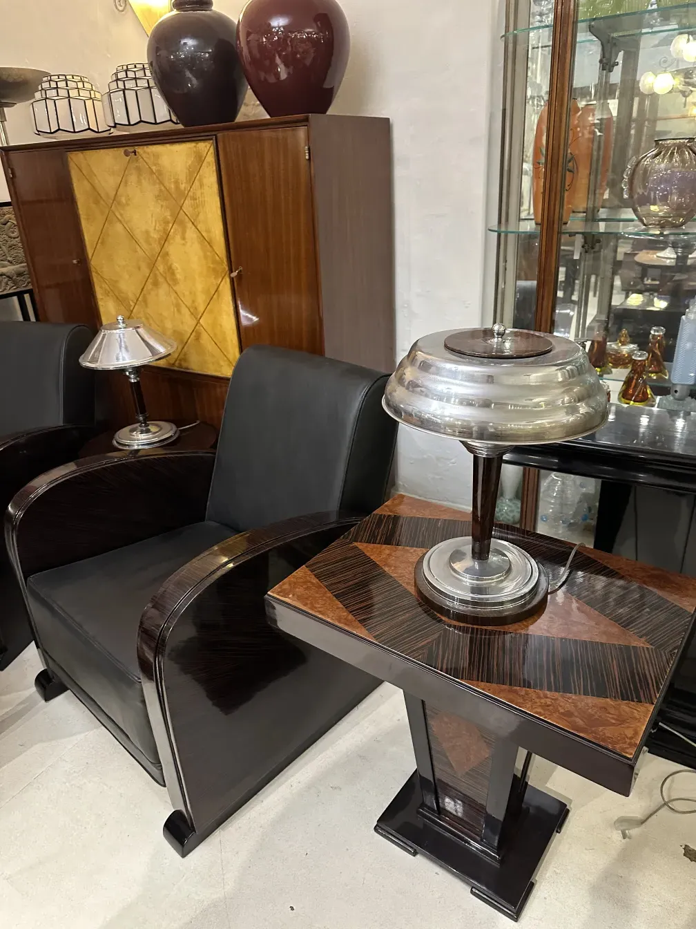 Kleiner antiker Tisch mit elegantem Design, umgeben von Dekoartikeln.