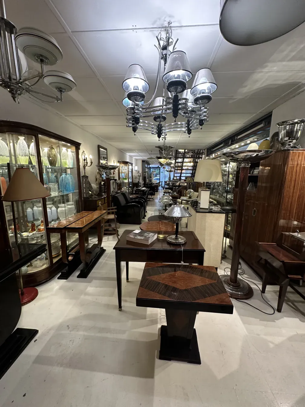 mesita antigua con detalles elaborados y elegante diseño, rodeada de antigüedades