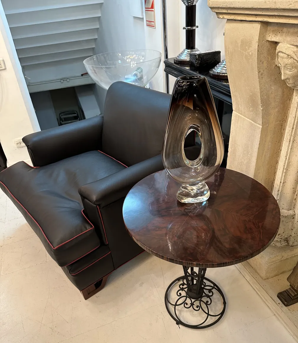 2 antique round tables beside a black sofa