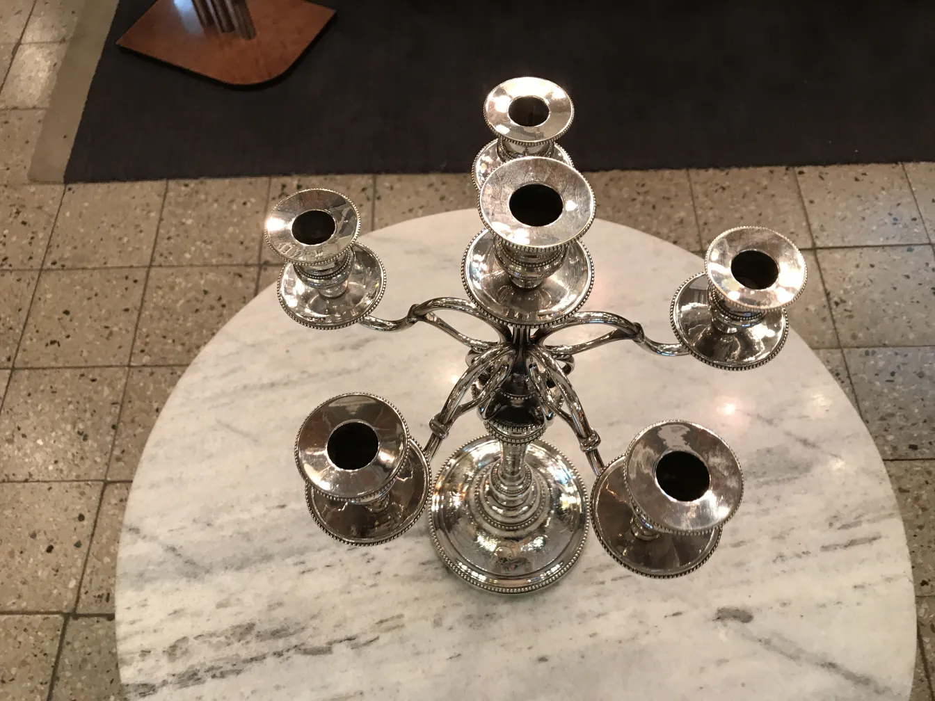 Two antique art nouveau candelabras on a table