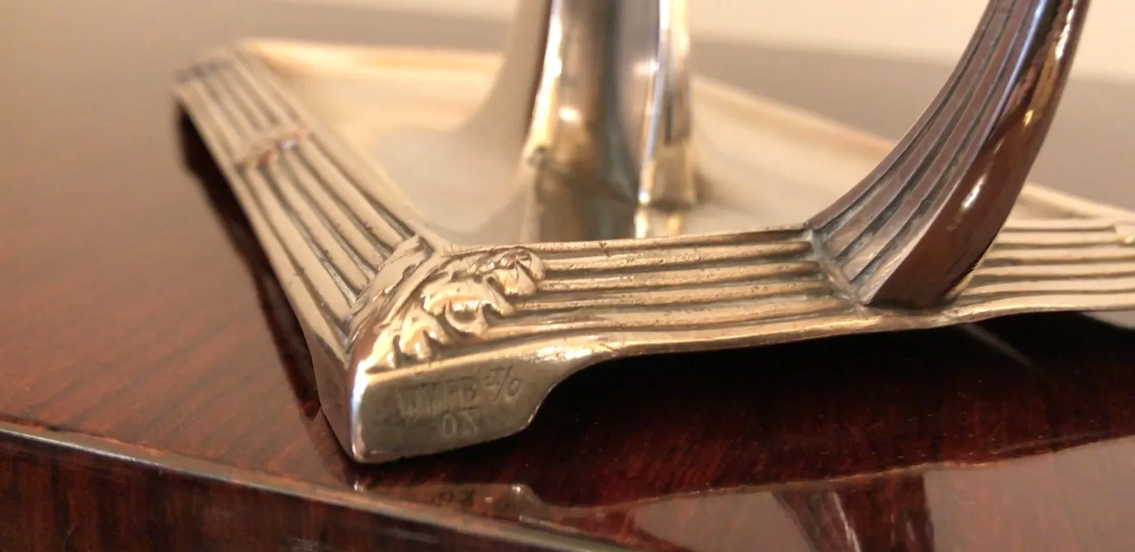 Вид двух старинных подсвечников с детализированным орнаментом, темный фон.