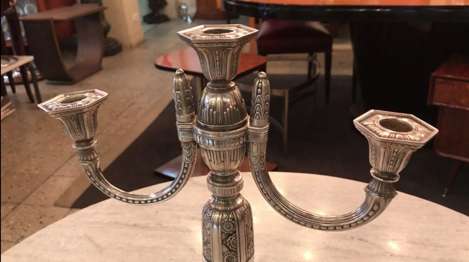 due candelabri antichi con disegni decorativi