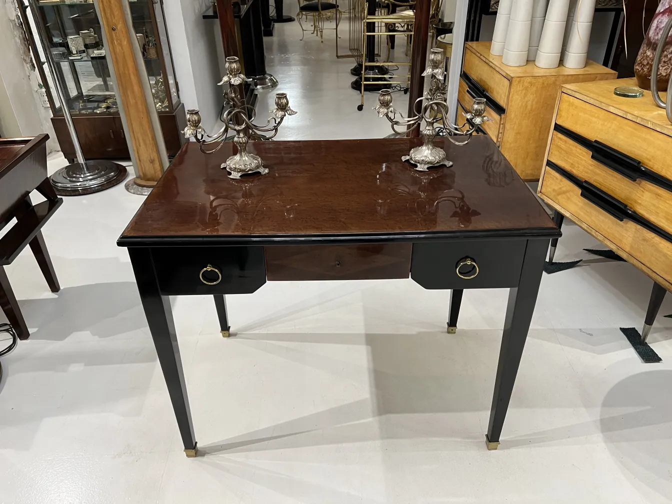 two antique candelabras on wooden table
