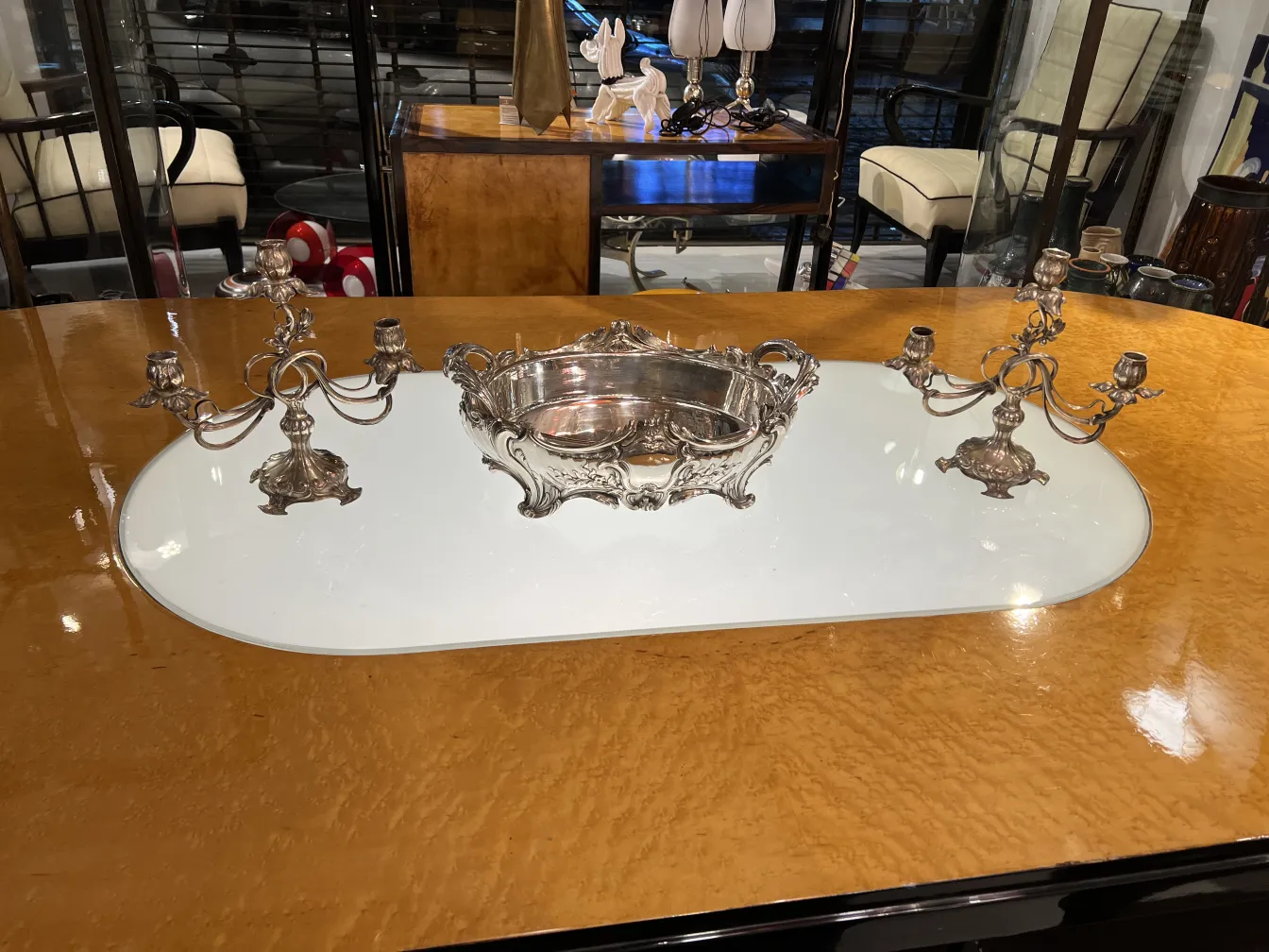 Two antique candelabras with floral ornamentation in a decorative setup.