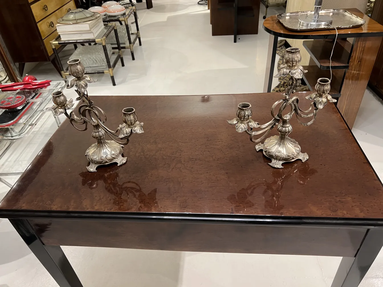 Two antique candelabras with elegant design on a table