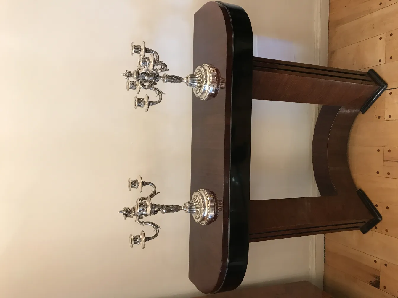 2 antique candle holders on a decorative table