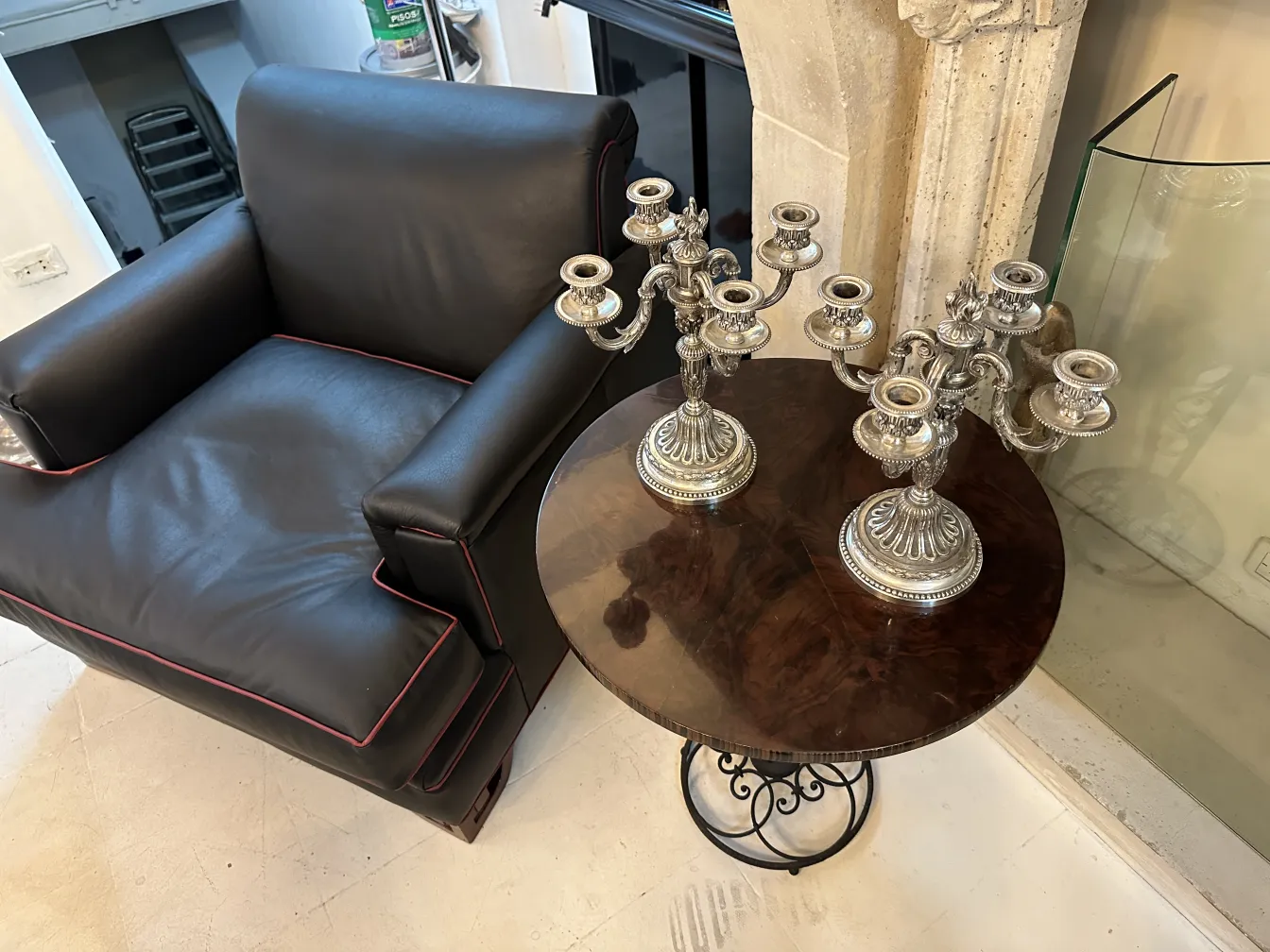 two antique candelabras art nouveau on table with black chair