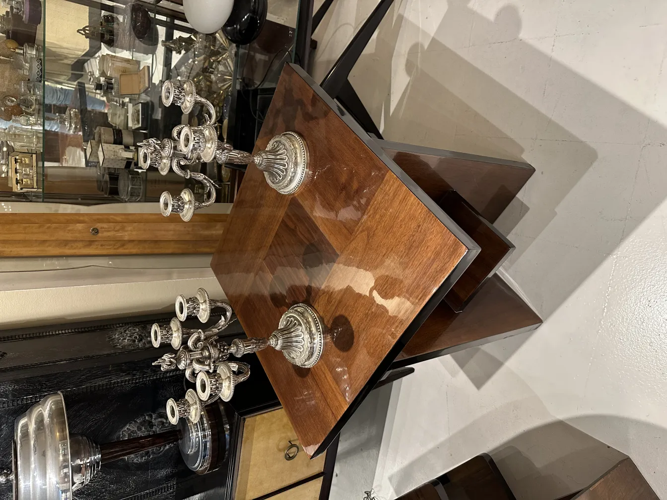 Two antique art nouveau candlesticks on an elegant table.