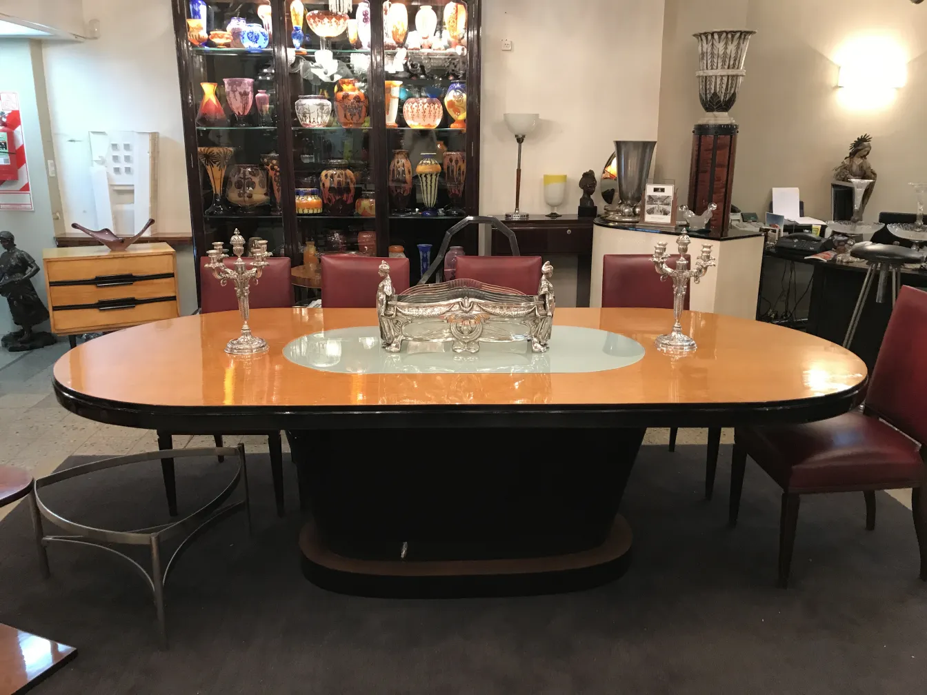 2 antique candle holders on an elegant table with surroundings