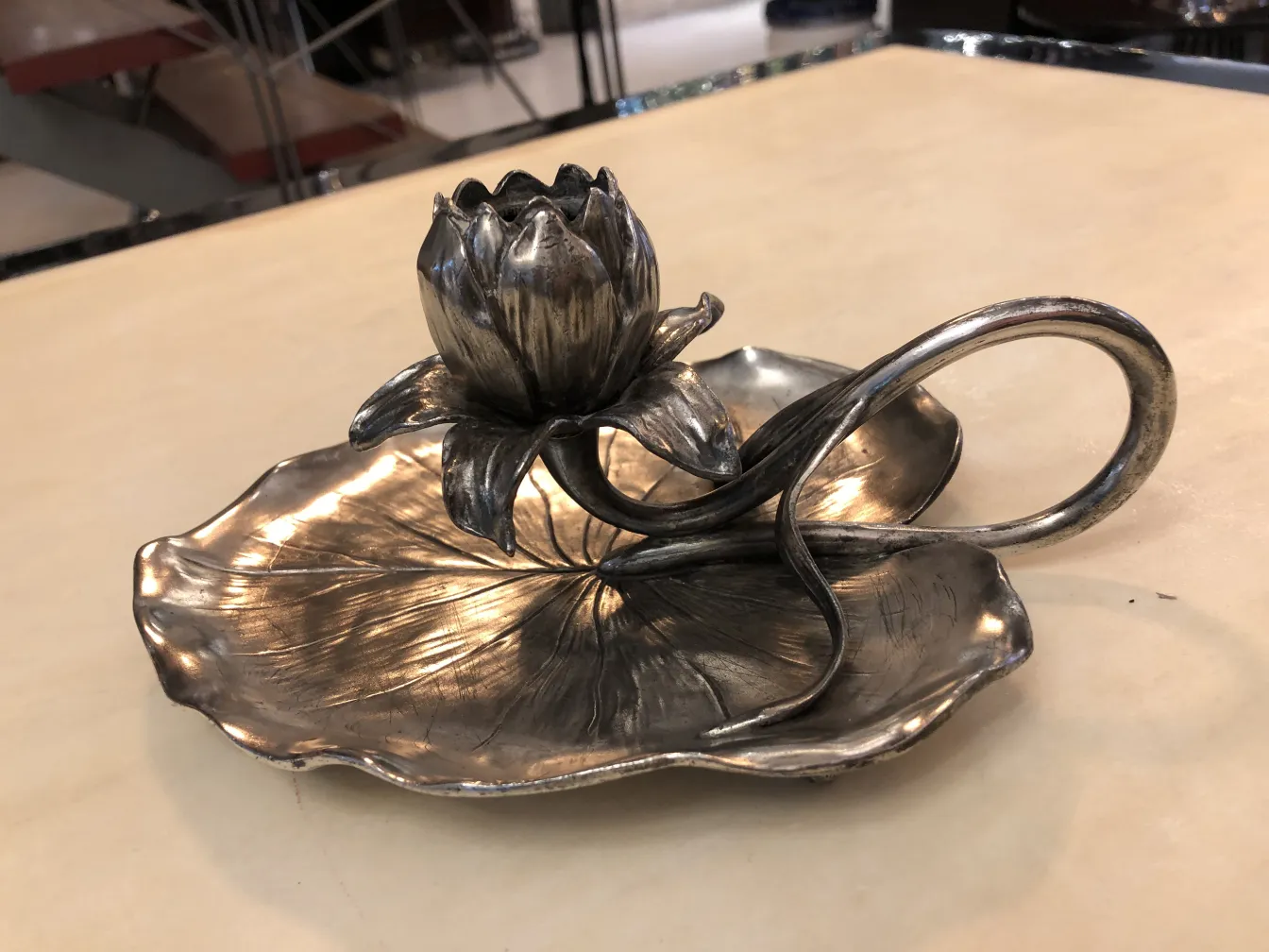 antique candelabra with floral design on round base