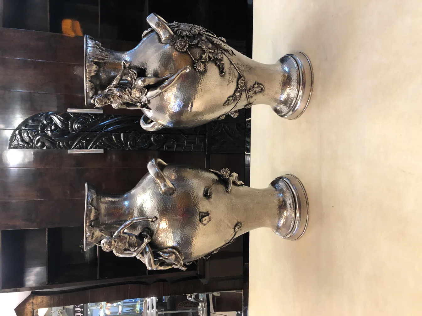 Set of 2 antique art nouveau vases, featuring decorative details and a shiny finish on a neutral surface.