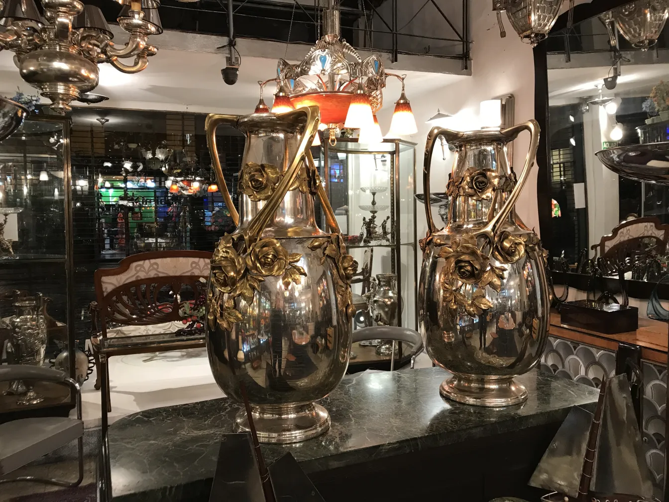 Two antique art nouveau vases with gold details, classic decorative setting.