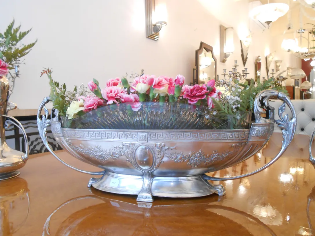 silver vases with colorful flowers in an antique setting