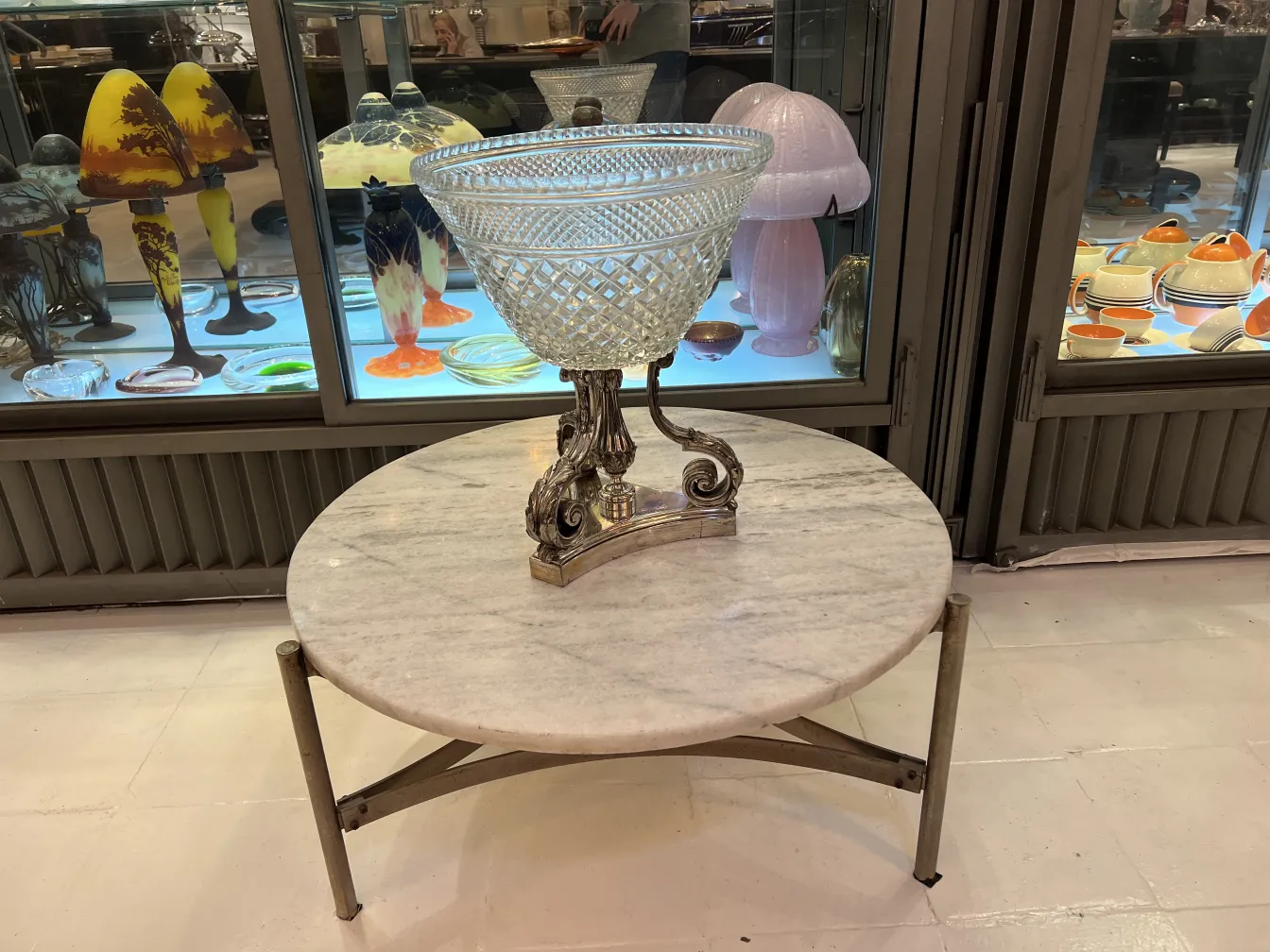 antique glass vase on a table with decorative base, background with accessories