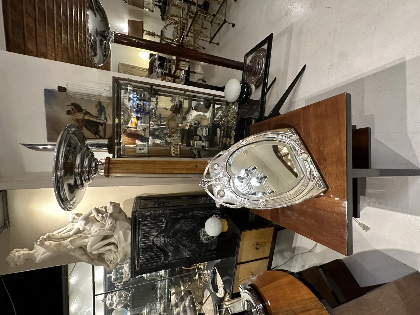 Antique mirror features Art Nouveau design in a stylish setting.