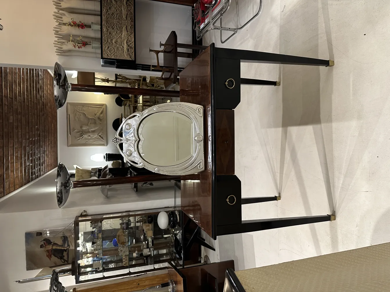 Antique Art Nouveau mirror with decorative frame in an elegant setting.