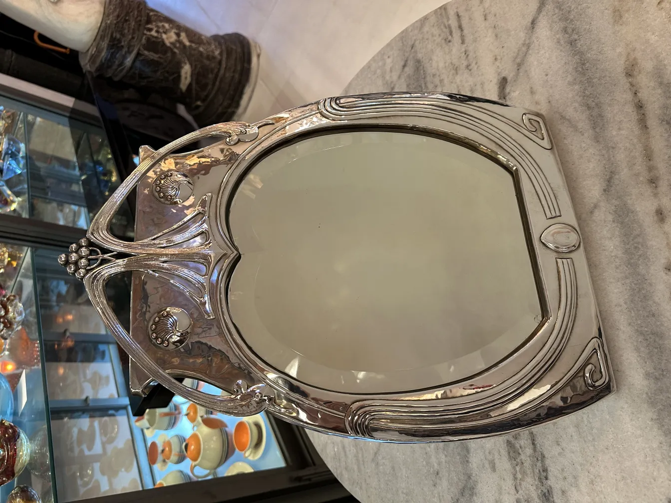 antique bathroom mirror with art nouveau design in a cozy setting