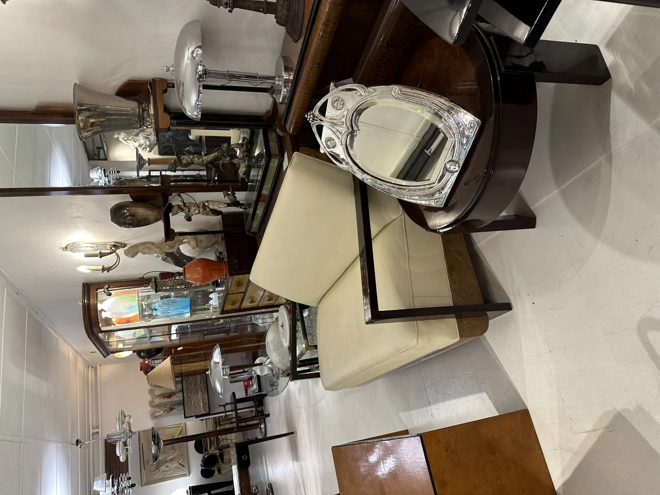 Antique mirror featuring Art Nouveau design in a decorated room.