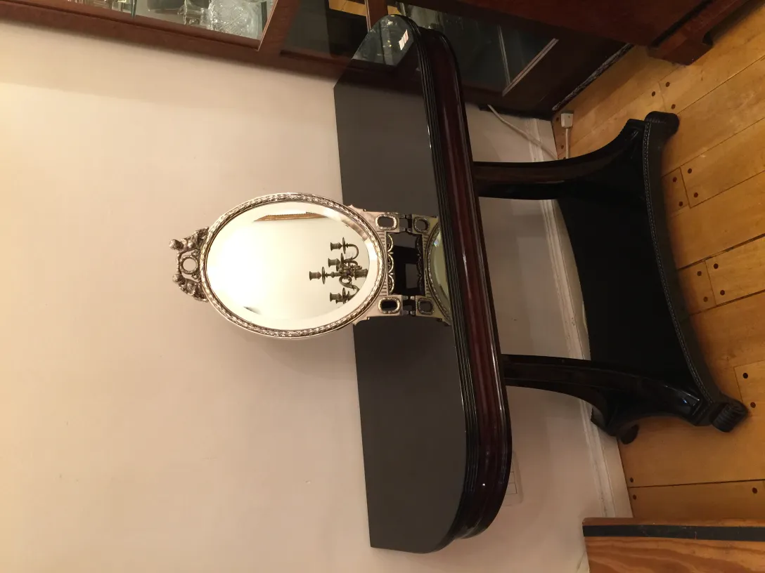 antique oval mirror with decorative details in an elegant setting