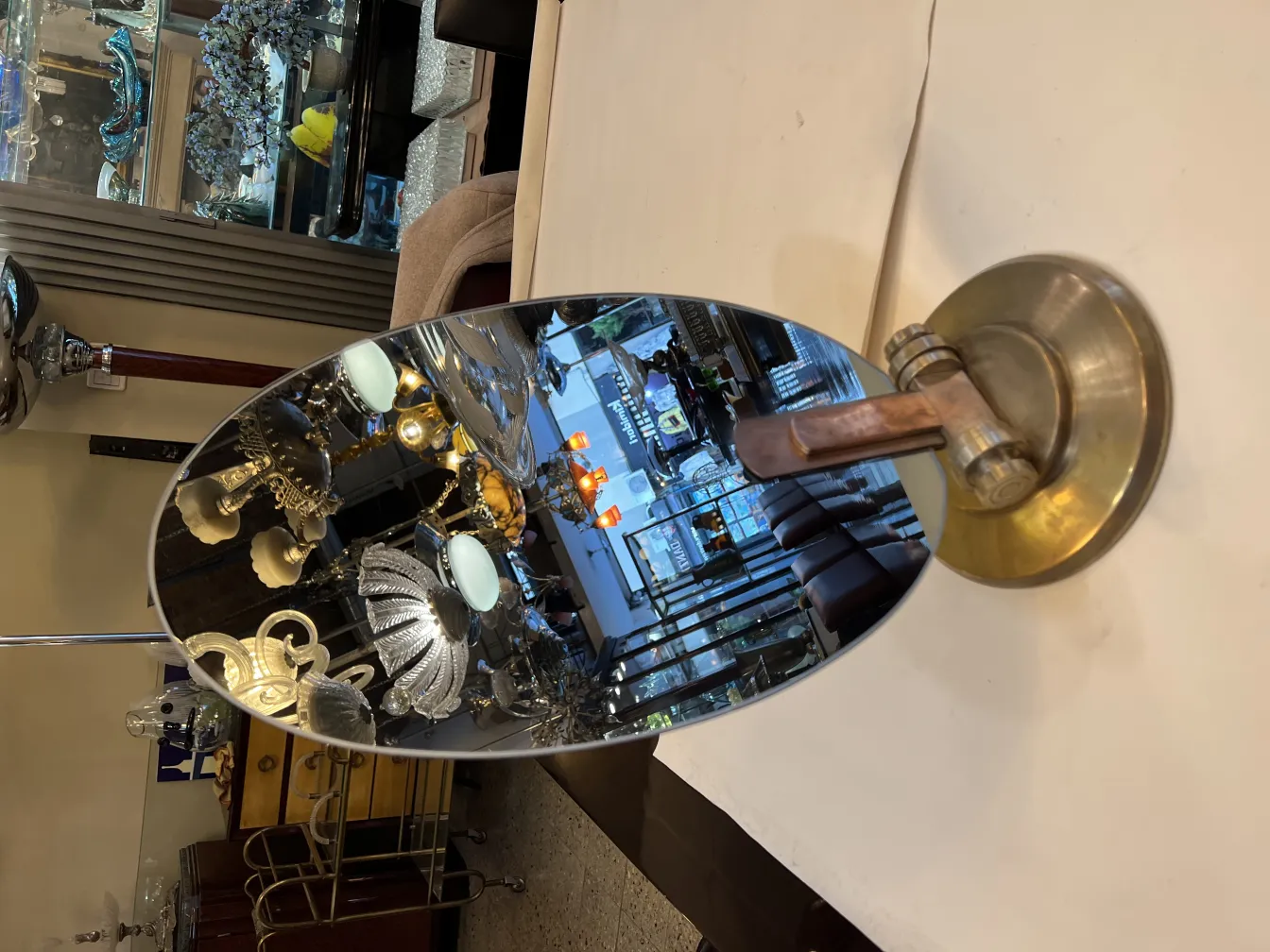 Antique table mirror with Art Nouveau design, oval shape and decorative base, in an elegant setting.