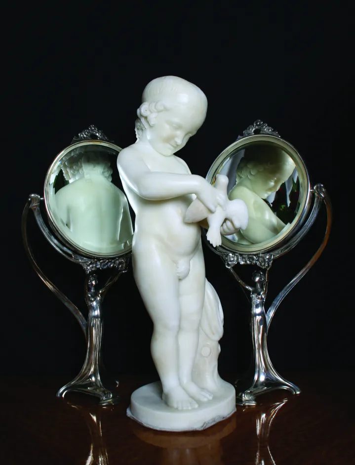 Antique mirror with child holding a dove, wings details.