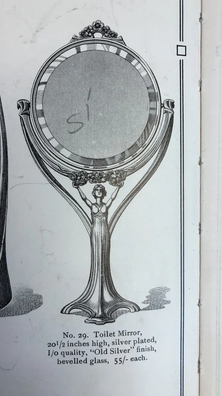 espelho antigo com um design artístico na moldura e um suporte elegante.