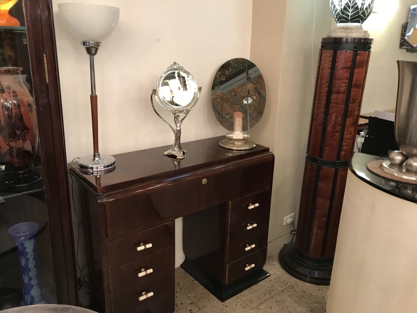 antique mirror with decorative base on a dresser